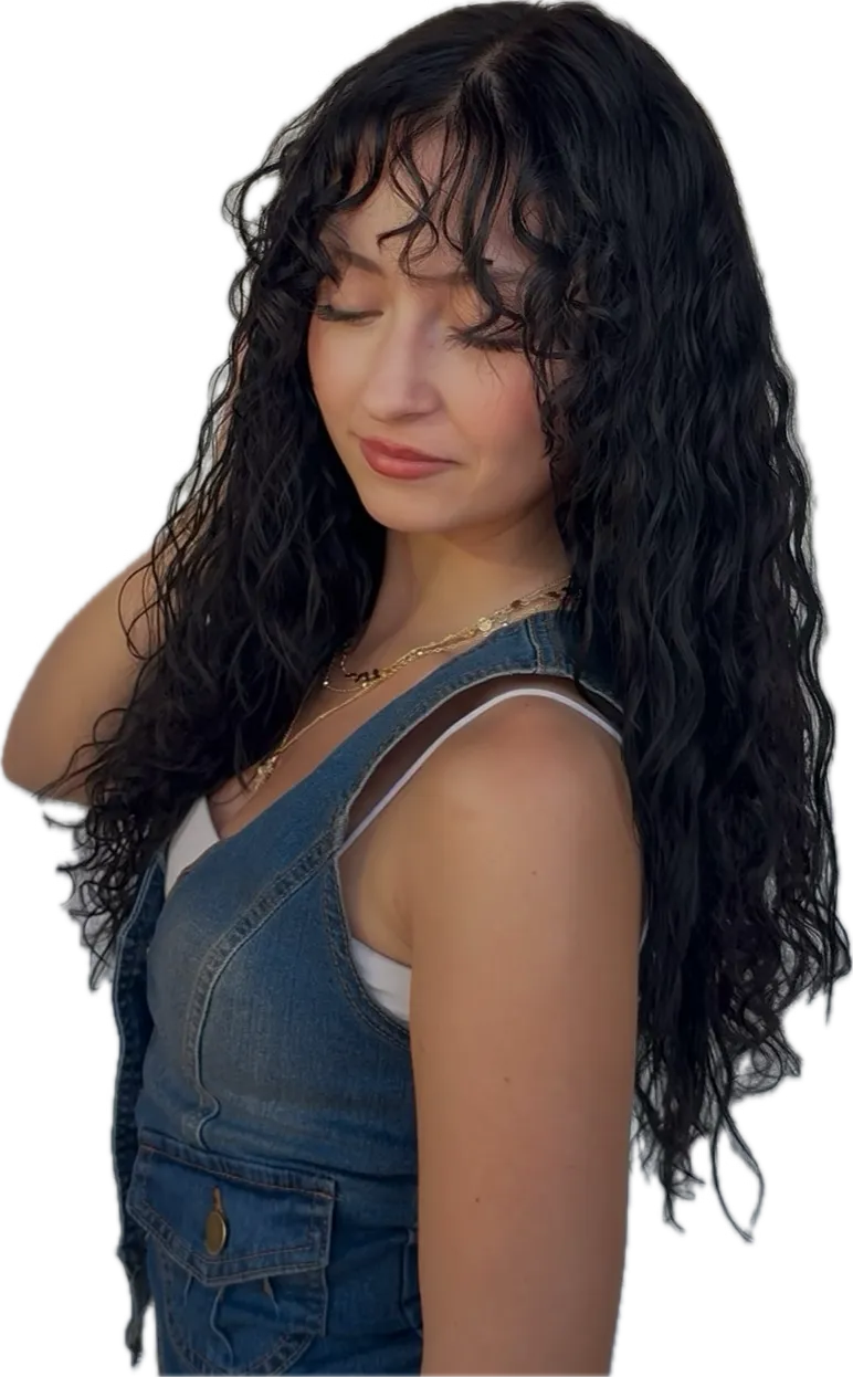 Client with long, dark curly hair and curtain bangs